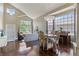 Spacious living room showcasing hardwood floors, vaulted ceilings, and an adjacent dining area at 2261 Alpine Dr, Erie, CO 80516