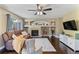 Inviting living room features a ceiling fan, tile fireplace with built-ins, and a comfortable seating area at 2261 Alpine Dr, Erie, CO 80516