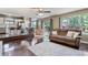 Open concept living area connects to kitchen and dining area; features hardwood floors, comfortable seating, and natural light at 2261 Alpine Dr, Erie, CO 80516