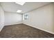 Finished basement featuring neutral carpet and a window at 43343 E Arkansas Pl, Bennett, CO 80102