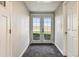 Basement hallway with French doors leading outside at 43343 E Arkansas Pl, Bennett, CO 80102