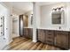 A main bathroom features double vanities, wood-look flooring, and a walk-in closet at 43343 E Arkansas Pl, Bennett, CO 80102