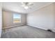 Neutral bedroom featuring carpeted floors, ceiling fan, and a window providing natural light at 43343 E Arkansas Pl, Bennett, CO 80102