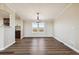 Bright dining room with modern light fixture, views from the windows, and wood-style flooring at 43343 E Arkansas Pl, Bennett, CO 80102