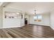 Bright dining room featuring modern light fixture, wood-style flooring, and views of the surrounding land at 43343 E Arkansas Pl, Bennett, CO 80102
