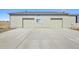 Attached two-car garage with an expansive driveway at 43343 E Arkansas Pl, Bennett, CO 80102
