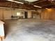 Spacious garage interior featuring built in storage and concrete flooring at 43343 E Arkansas Pl, Bennett, CO 80102