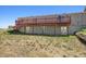 Rear view of the house, showcasing the deck and surrounding landscape at 43343 E Arkansas Pl, Bennett, CO 80102