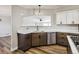Open kitchen area shows stainless steel appliances, marble counters, and a view of the living room at 43343 E Arkansas Pl, Bennett, CO 80102