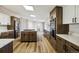 Modern kitchen with stainless appliances, quartz countertops, and an island at 43343 E Arkansas Pl, Bennett, CO 80102