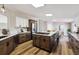 A modern kitchen features wooden floors, white cabinetry, and a large center island with a built-in stovetop at 43343 E Arkansas Pl, Bennett, CO 80102