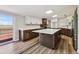 Spacious kitchen with island, stainless appliances, and access to the outdoor deck at 43343 E Arkansas Pl, Bennett, CO 80102