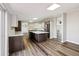 The large kitchen features an island, stainless appliances, and a view of the living room at 43343 E Arkansas Pl, Bennett, CO 80102