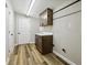 Mud/laundry room featuring tile floor, cabinet with white countertop, and a convenient hanging rod at 43343 E Arkansas Pl, Bennett, CO 80102