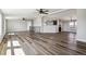 Open-concept living room boasts hardwood floors, ceiling fans, and natural light at 43343 E Arkansas Pl, Bennett, CO 80102