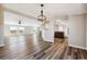 Open-concept living room featuring wood-style flooring and views of the surrounding landscape through large windows at 43343 E Arkansas Pl, Bennett, CO 80102