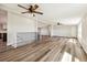 Spacious open-concept living area with hardwood floors and plenty of natural light at 43343 E Arkansas Pl, Bennett, CO 80102