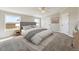 This cozy main bedroom features a large window, neutral carpeting and tones, and simple decor at 43343 E Arkansas Pl, Bennett, CO 80102
