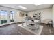 Bright home office with desk, chair, bookshelf, and French doors leading to a backyard view at 43343 E Arkansas Pl, Bennett, CO 80102