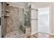 Walk-in shower with glass enclosure and built-in seat at 43343 E Arkansas Pl, Bennett, CO 80102