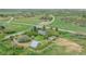 Aerial view of the property showing the home, barn, and surrounding greenery at 6334 Cherokee Dr, Sedalia, CO 80135