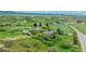 Aerial view of the property showing a home, barn, and surrounding landscape at 6334 Cherokee Dr, Sedalia, CO 80135