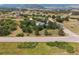 A captivating aerial view of the property showcasing rolling hills and mature trees at 6334 Cherokee Dr, Sedalia, CO 80135