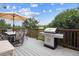 Spacious wooden deck with a grill and dining area, offering an ideal space for outdoor entertaining and relaxation at 6334 Cherokee Dr, Sedalia, CO 80135