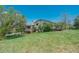 View of the backyard featuring a deck, lush lawn, and mature trees at 6334 Cherokee Dr, Sedalia, CO 80135