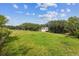 Landscaped backyard featuring a level lawn, mature trees, and a storage shed at 6334 Cherokee Dr, Sedalia, CO 80135
