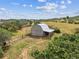 Charming barn nestled in a serene, rural landscape with a metal roof and wood siding at 6334 Cherokee Dr, Sedalia, CO 80135