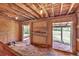 Rustic barn interior featuring wood walls, beamed ceiling, and ample natural light at 6334 Cherokee Dr, Sedalia, CO 80135