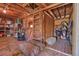 Spacious barn interior with wooden beams, hay bales, and ample storage at 6334 Cherokee Dr, Sedalia, CO 80135