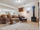 Finished basement space with bar, decorative rug, and wood burning stove at 6334 Cherokee Dr, Sedalia, CO 80135
