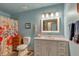 A tranquil bathroom featuring light blue walls, vanity, and vibrant floral-themed shower curtain at 6334 Cherokee Dr, Sedalia, CO 80135