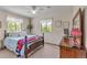 A light-filled bedroom with windows and a decorative bed frame with dresser at 6334 Cherokee Dr, Sedalia, CO 80135