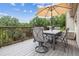 Relaxing deck with an umbrella-covered table, chairs, and a grill, perfect for outdoor dining and entertaining at 6334 Cherokee Dr, Sedalia, CO 80135