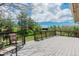 A spacious deck with a view of the grassy yard and barn, perfect for outdoor relaxation and entertaining at 6334 Cherokee Dr, Sedalia, CO 80135
