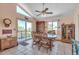 Bright dining room with vaulted ceilings, large windows, sliding door to deck, and tile floors at 6334 Cherokee Dr, Sedalia, CO 80135
