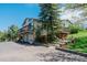 Charming home with multiple decks, two-car garage, and landscaped yard showcasing curb appeal and outdoor living spaces at 6334 Cherokee Dr, Sedalia, CO 80135