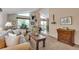 Spacious living room with vaulted ceilings, large windows with natural light, and comfortable seating arrangements at 6334 Cherokee Dr, Sedalia, CO 80135
