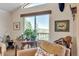 Bright living room featuring a scenic view, vintage table with plants, and cozy seating with saddle on chair at 6334 Cherokee Dr, Sedalia, CO 80135