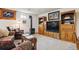 Cozy living room with built-in wooden shelving, decorative horse art, a wood-burning stove, and comfortable seating at 6334 Cherokee Dr, Sedalia, CO 80135