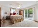 Serene main bedroom features a ceiling fan, outdoor access, and ample natural light at 6334 Cherokee Dr, Sedalia, CO 80135
