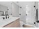 Sleek bathroom featuring a glass-enclosed shower, modern fixtures, and wood-look flooring at 1500 S Elizabeth St, Denver, CO 80210