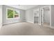 Open bedroom with a large window and walk-in closet with an attached bathroom at 1500 S Elizabeth St, Denver, CO 80210