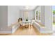 Charming breakfast nook featuring bench seating, a round table, and natural light from large windows at 1500 S Elizabeth St, Denver, CO 80210
