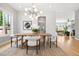 Bright dining room featuring stylish light fixture, wood table, and a view into the living room at 1500 S Elizabeth St, Denver, CO 80210