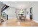 Bright dining area with modern chandelier, leading to staircase and views of the outdoors at 1500 S Elizabeth St, Denver, CO 80210