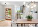 Modern entryway features an open staircase, light hardwood floors, and a stylish front door at 1500 S Elizabeth St, Denver, CO 80210